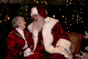 Mrs Claus & Santa looking at each other and laughing